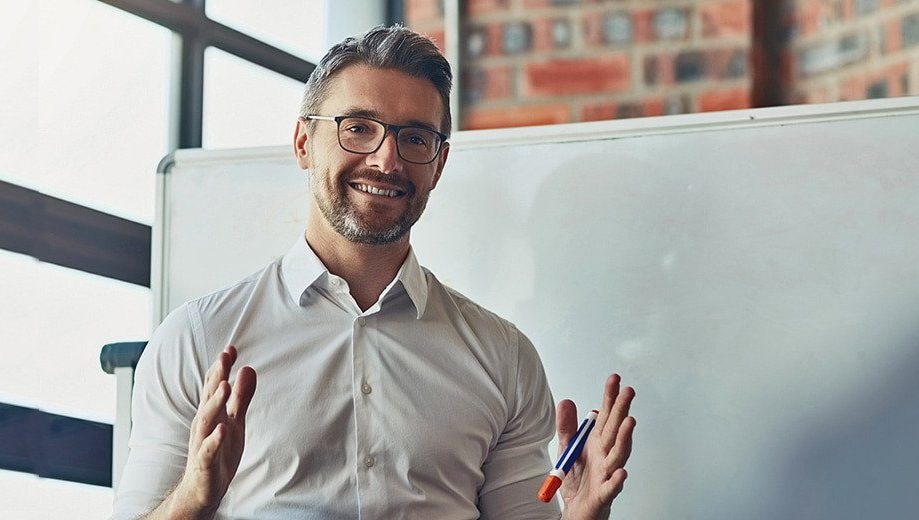 High school teacher in front of whiteboard