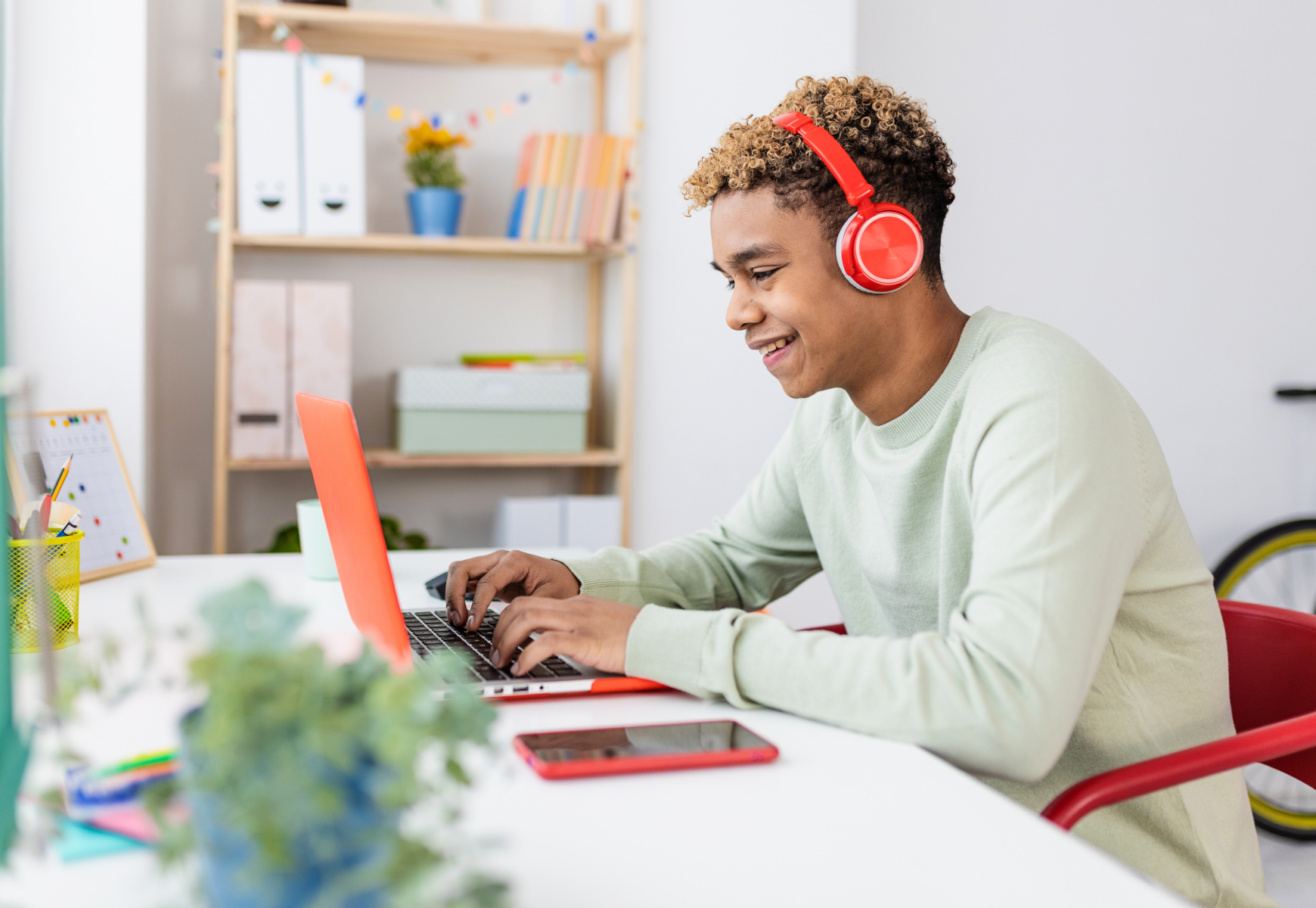 Young teenage boy studying online at home